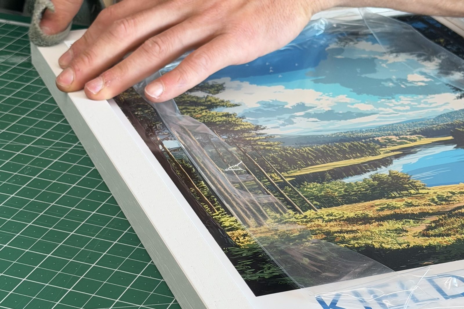 A finished framed print in a white wooden frame, ready to hang